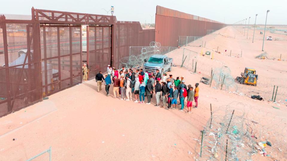 PHOTO: In an aerial view, immigrants wait for transport and processing after crossing the U.S.-Mexico border March 13, 2024 in El Paso, Texas. (John Moore/Getty Images, FILE)