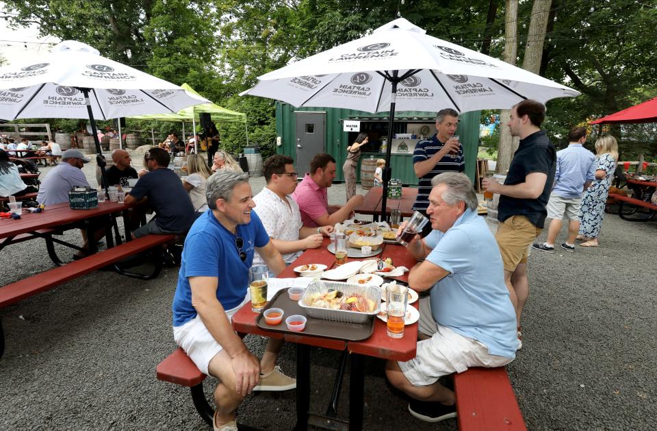 Enjoying the beer – and the beer garden – at Captain Lawrence in Elmsford.  The brewery is known for brewing extremely fresh IPAs, highly drinkable lagers and a variety of craft specialty beers.  Photographed August 2023.