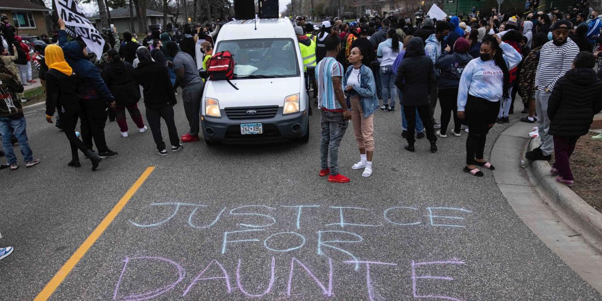 People gather in protest, Sunday, April 11, 2021, in Brooklyn Center, Minn. The family of Daunte Wright, 20, told a crowd that he was shot by police Sunday before getting back into his car and driving away, then crashing the vehicle several blocks away. The family said Wright was later pronounced dead.