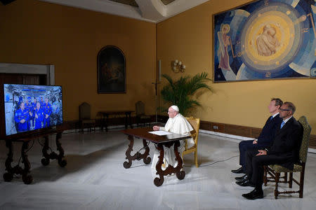 Pope Francis talks with crew members of the International Space Station, ISS Expedition 53, during an audio-video connection at the Vatican October 26, 2017. Osservatore Romano/Handout via Reuters