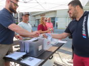 Members of Local 54 of the Unite Here union sign up for reduced-rate strike pay on the Boardwalk in Atlantic City, N.J., on Thursday, June 30, 2022. Atlantic City’s top-performing casino, the Borgata, reached a tentative agreement on a new contract with the city’s main casino workers’ union on Thursday evening avoiding a strike. (AP Photo/Wayne Parry)