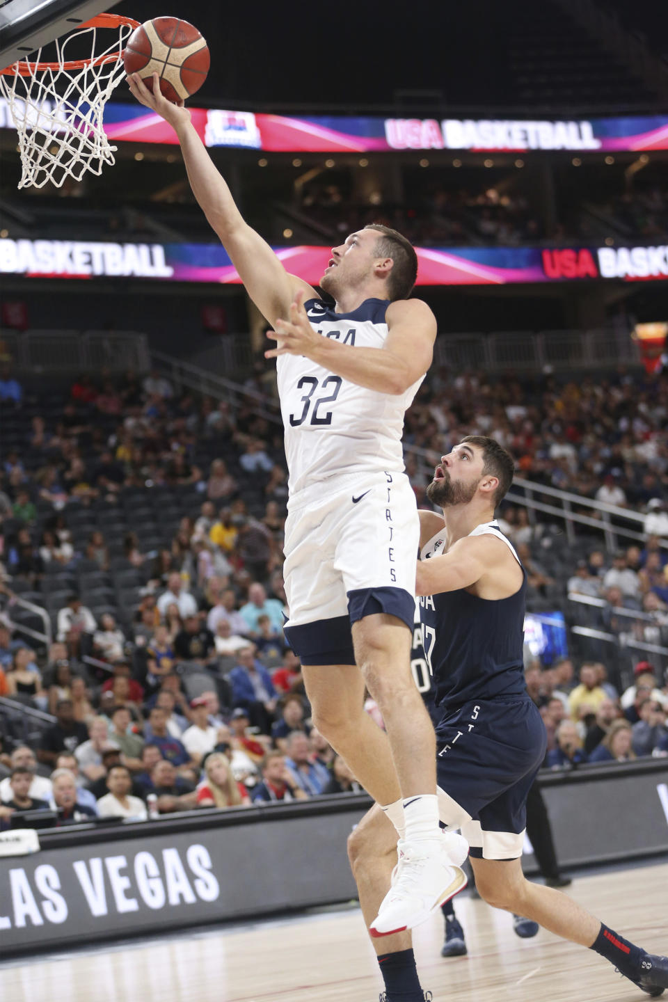 Team White guard Pat Connaughton (32) goes up for a shot against pressure from Team Blue guard Joe Harris (47) during the first half of the U.S. men's basketball team's scrimmage in Las Vegas, Friday, Aug. 9, 2019. (Erik Verduzco/Las Vegas Review-Journal via AP)