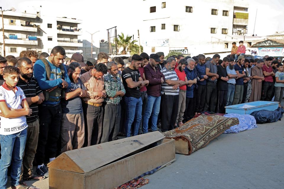 Syrians take part in the funeral of 10 fighters with the Turkey-backed Faylaq al-Sham rebel faction in Syria, in Idlib, on October 26, 2020, following their death in a Russian air strike.  (Photo by MOHAMMED AL-RIFAI/AFP via Getty Images) (AFP via Getty Images)