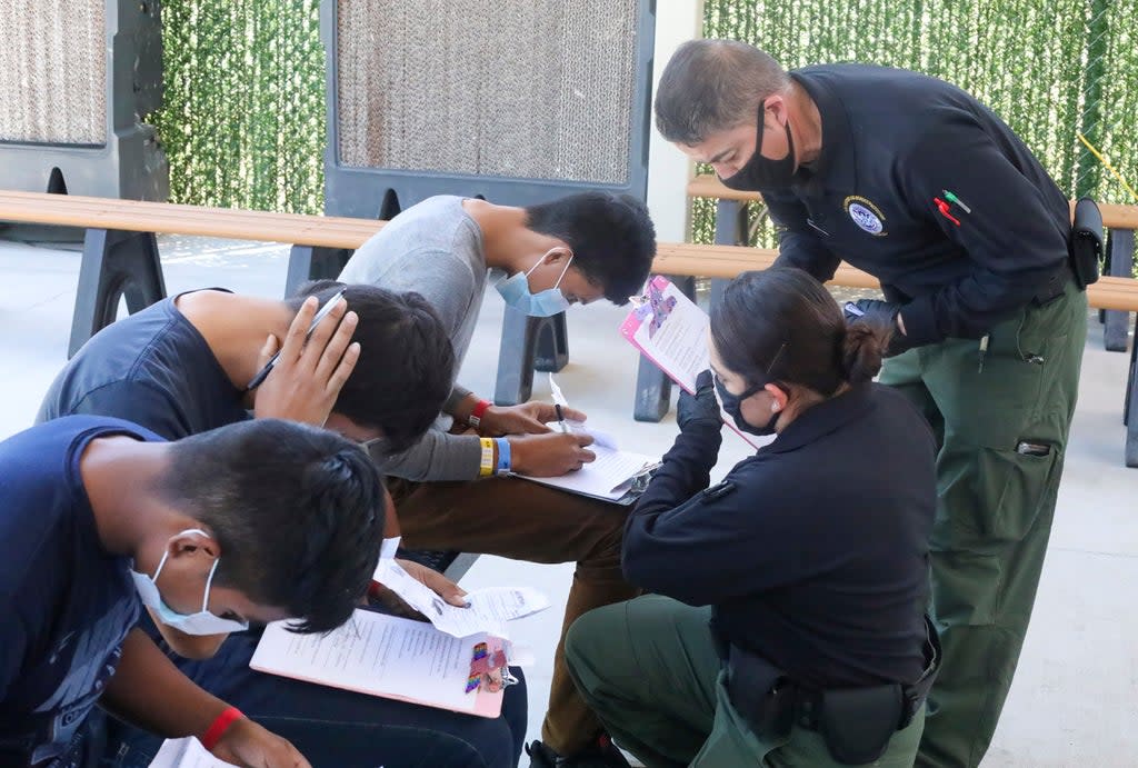 Border Patrol Processing Bottleneck (ASSOCIATED PRESS)