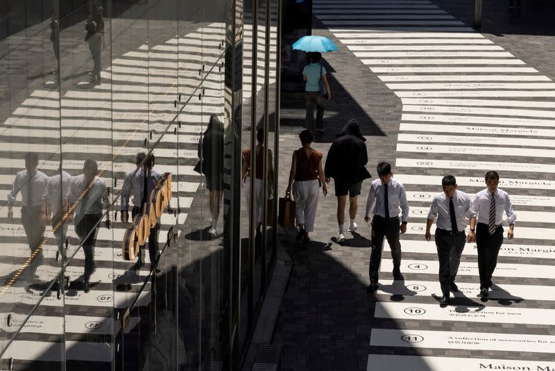 FILE PHOTO: People walk in a shopping district in Beijing