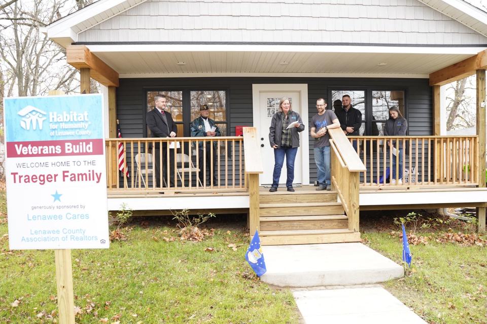 Wendy Knox, Habitat for Humanity of Lenawee County executive director, introduces new homeowner Joshua Traeger, a U.S. Air Force veteran, during the home dedication ceremony Friday, Nov. 11, 2022, in Adrian. Habitat built the house with the intent of having it go to a veteran.