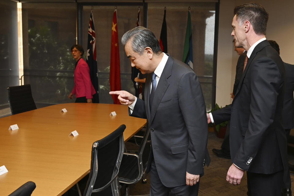 Chinese Foreign Minister Wang Yi, center, meets with New South Wales state Premier Chris Minns, right, during a visit to New South Wales Parliament House in Sydney, Thursday, March 21, 2024. Australia received its most senior Chinese leadership visit in nearly seven years with Wang's arrival Wednesday. (Dean Lewins/Pool Photo via AP)