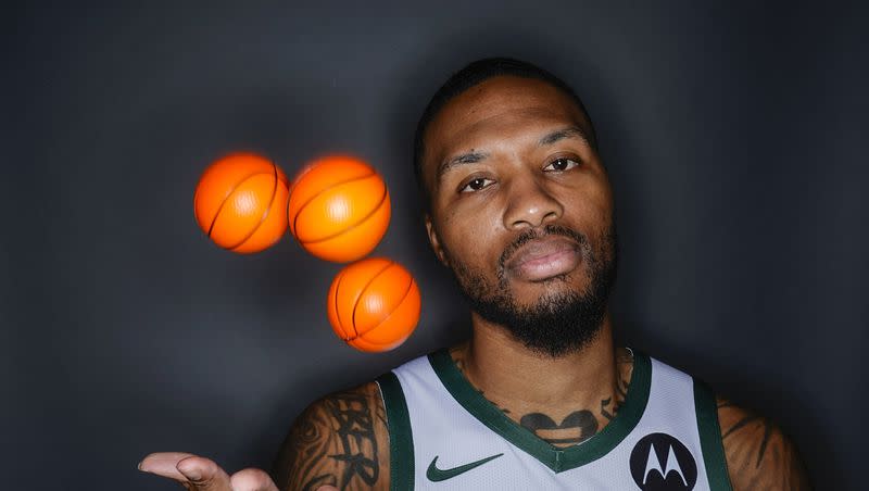Milwaukee Bucks’ Damian Lillard tosses some balls as he poses for a picture during the NBA basketball team’s media day in Milwaukee Monday, Oct. 2, 2023.