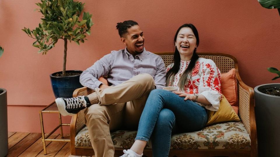 A man and woman laughing together.