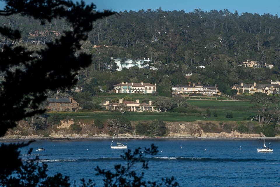 Two boats sail next to the Pebble Beach Golf Links that is homes to some of the most expensive homes in Monterey County in Pebble Beach, Calif., on Tuesday, Sept. 28, 2021.