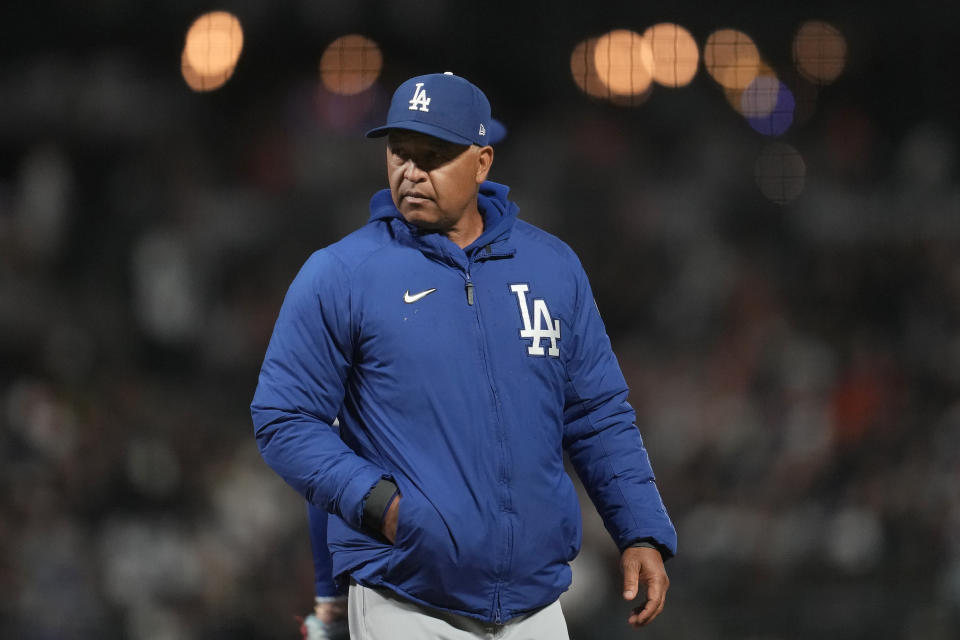 Los Angeles Dodgers manager Dave Roberts walks to the dugout after making a pitching change during the seventh inning of the team's baseball game against the San Francisco Giants in San Francisco, Monday, April 10, 2023. (AP Photo/Jeff Chiu)