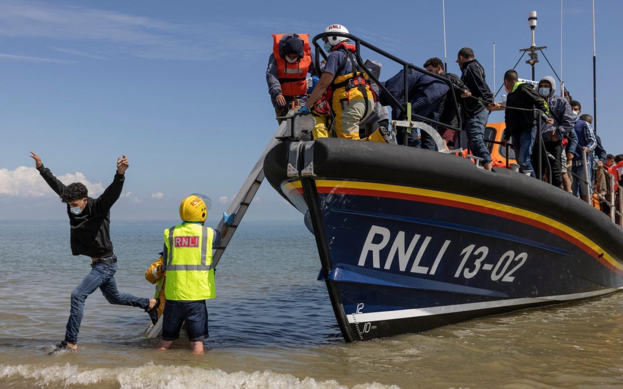 A migrant jumps ashore - Dan Kitwood/Getty Images