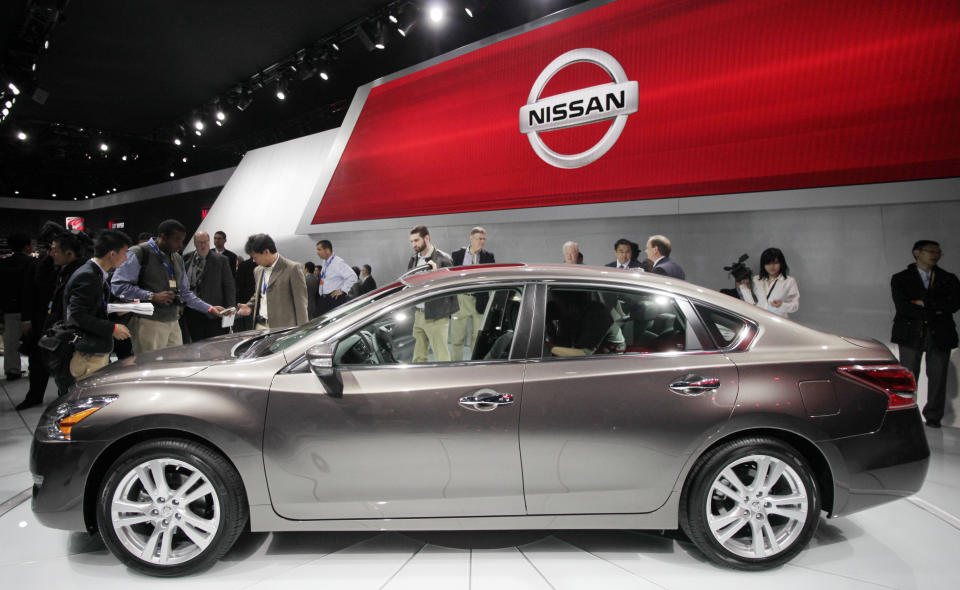 A crowd gathers around a 2013 Nissan Altima 3.5 SL sedan, Wednesday, April 4, 2012 at the New York International Auto Show. (AP Photo/Mark Lennihan)