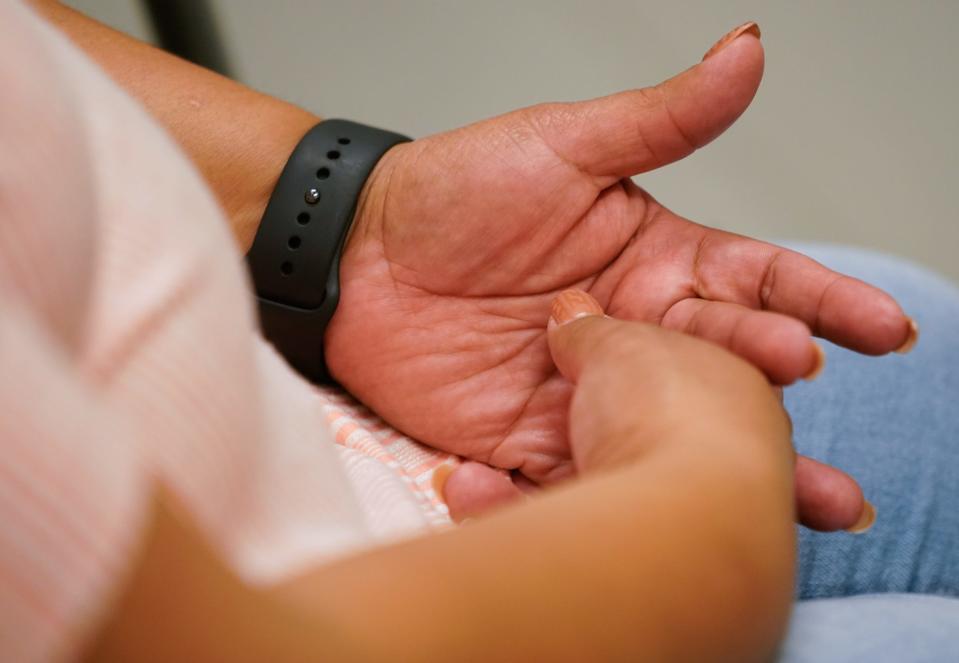Saura Fortin Erazo, M.D. sees a patient in Primary Care on Tuesday, Dec. 12, 2023, at Sidney & Lois Eskenazi Hospital in downtown Indianapolis. Shown here, the patients hands. As an Eskenazi Health provider, Fortin Erazo also staffs the urgent care clinic.