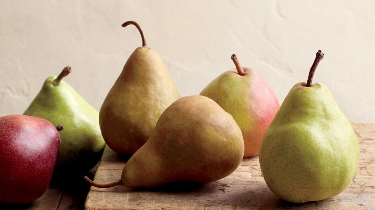 Variety of pears on wooden surface