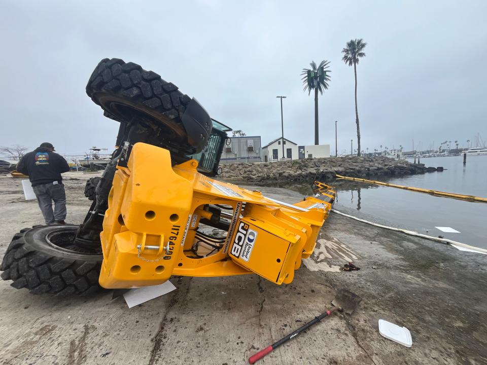 A forklift tipped over on its side on a concrete ramp at the Channel Islands Harbor in Oxnard on Monday.