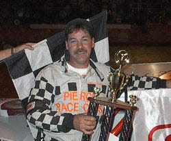 Mike Chasteen Sr. after taking the checkered flag and a trophy at Modified race in Spoon River Speedway in 2001.