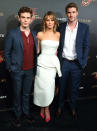 Sam Claflin, Jennifer Lawrence and Liam Hemsworth attend a party for 'The Hunger Games: Catching Fire' at The 66th Annual Cannes Film Festival at Baoli Beach on May 18, 2013 in Cannes, France.