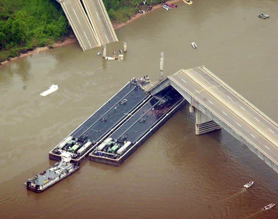 BRIDGE COLLAPSE, WEBBERS FALLS, I-40, INTERSTATE 40, BARGE, HIT, COLLISION, DEATH, DEATHS, ARKANSAS RIVER: A piece of the I-40 bridge over the Arkansas River near Webbers Falls, Okla., rests on a barge that collided with the bridge Sunday morning, May 26, 2002. This aerial view is looking north west.