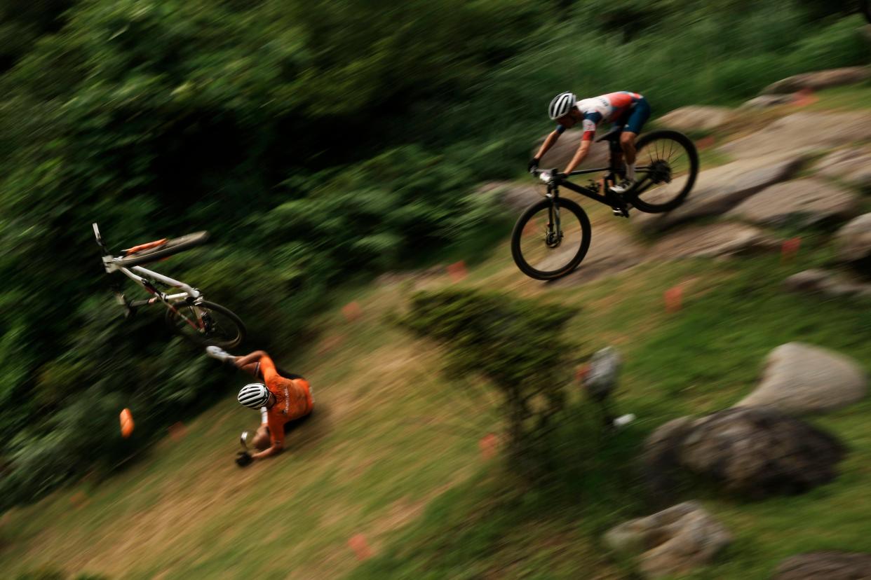 Mathieu van der Poel of the Netherlands tumbles on a downhill during the men's cross country mountain bike competition at the 2020 Summer Olympics, Monday, July 26, 2021, in Izu, Japan.