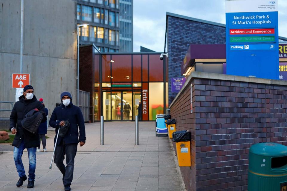 People wearing masks as a precautionary measure against Covid-19 leave Northwick Park Hospital: AFP via Getty Images