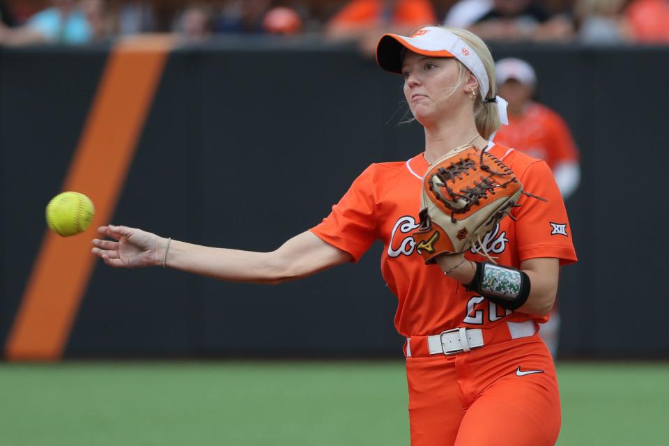 Oklahoma State's Rosie Davis (26) throws to first for an out during a college softball game between the Oklahoma State University Cowgirls and the Texas Longhorns in Stillwater, Okla., Saturday, March 30, 2024. Oklahoma State won 3-0.