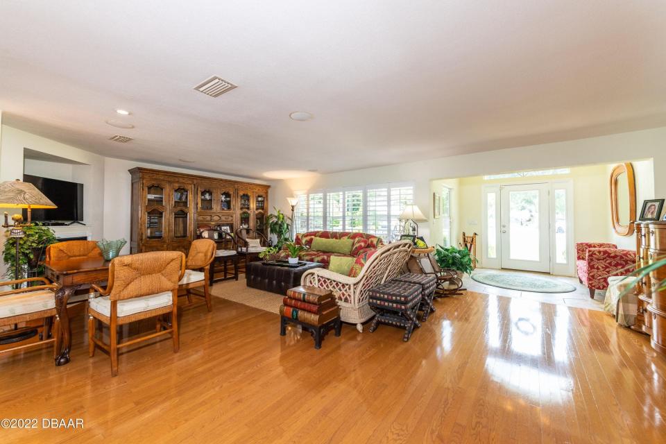 Walk into glistening wood floors that cover this lovely living area.