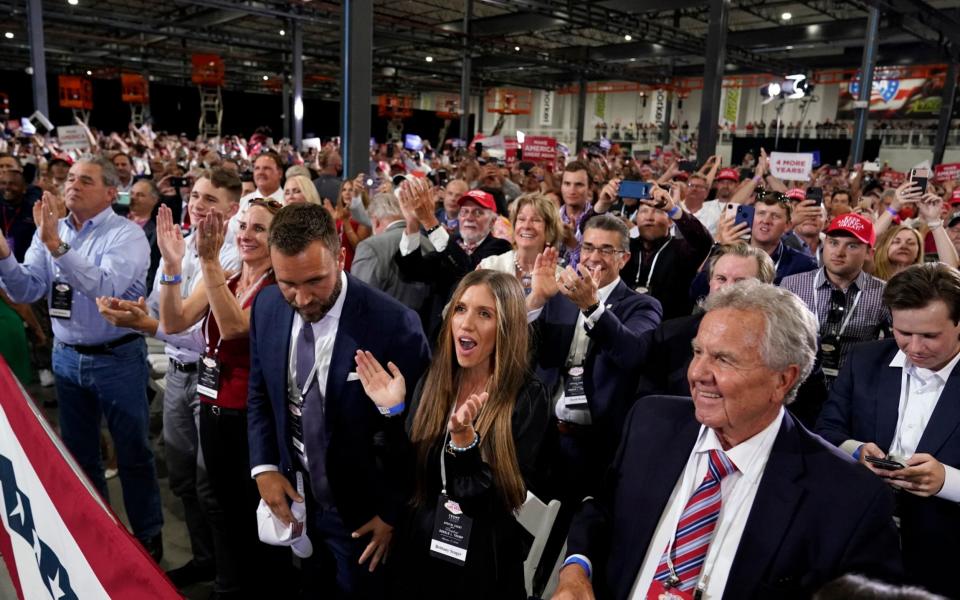 Supporters cheer as President Donald Trump speaks at a rally at Xtreme Manufacturing - AP