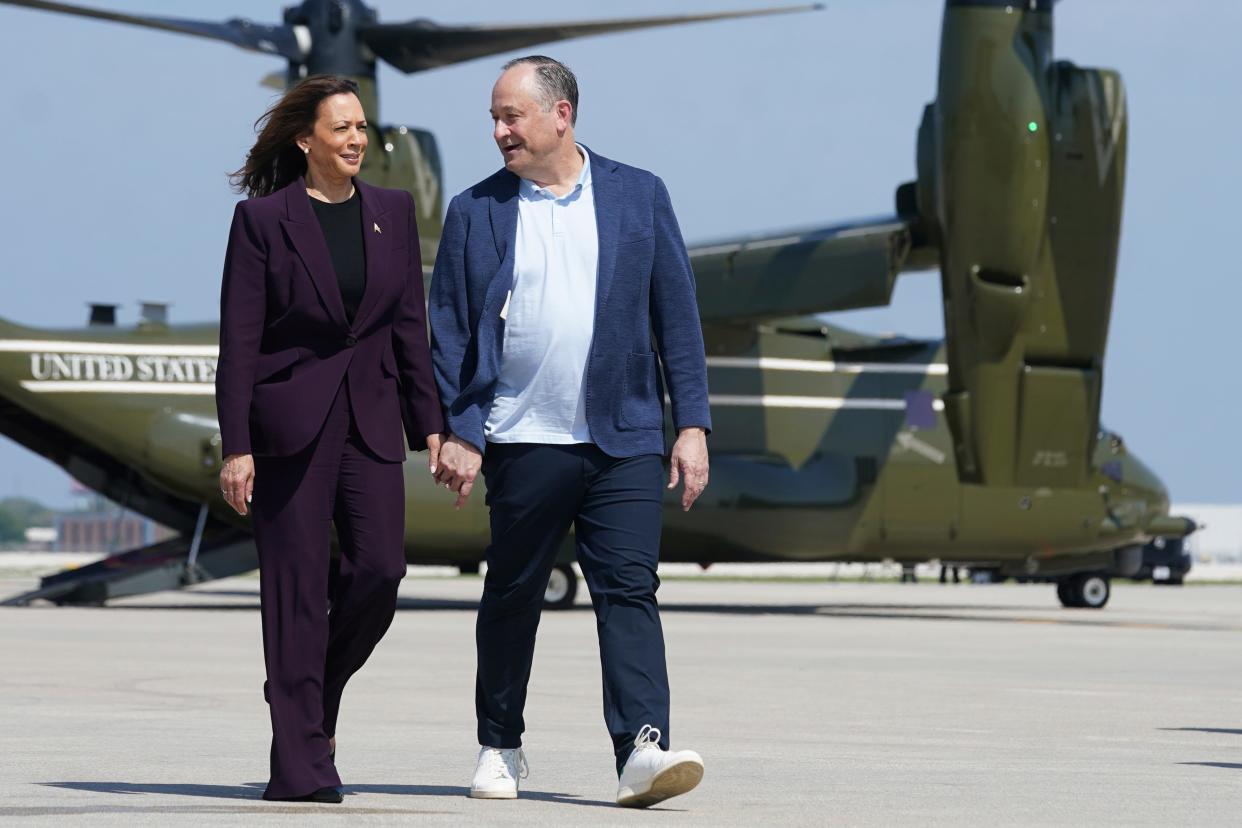 Kamala Harris, left, and second gentleman Doug Emhoff walk from Marine Two to board Air Force Two at Chicago’s O’Hare airport on August 23. (AP)