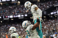 Miami Dolphins offensive guard Robert Hunt (68) holds up wide receiver Will Fuller (3) after Fuller scored a two-point conversion against the Las Vegas Raiders during the second half of an NFL football game, Sunday, Sept. 26, 2021, in Las Vegas. (AP Photo/Rick Scuteri)