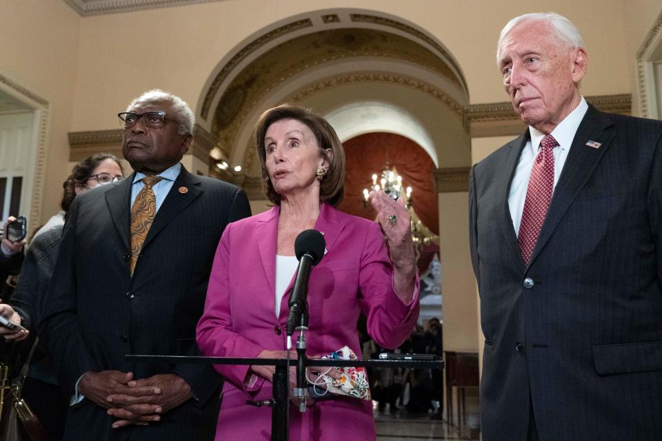 Speaker of the House Nancy Pelosi, D-Calif., accompanied by House Majority Whip James Clyburn, D-S.C., left and House Majority Leader Steny Hoyer D-MD, speaks to reporters at the Capitol in Washington, Friday, Nov. 5, 2021, as the House is considering President Joe Biden's $1.85 trillion-and-growing domestic policy package. (AP Photo/Jose Luis Magana) ORG XMIT: DCJL132