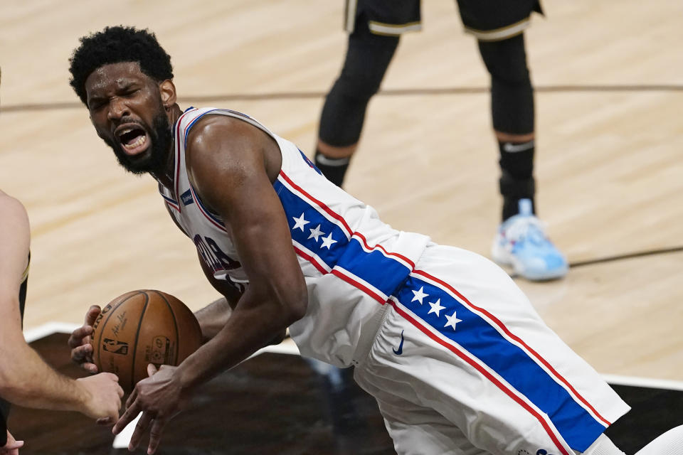Philadelphia 76ers center Joel Embiid falls to the floor after fouling an Atlanta Hawks player during the first half of Game 6 of an NBA basketball Eastern Conference semifinal series Friday, June 18, 2021, in Atlanta. (AP Photo/John Bazemore)