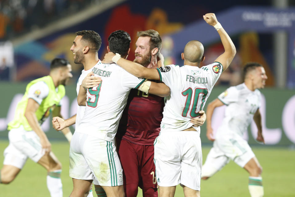 Algerian players celebrate after the African Cup of Nations final soccer match between Algeria and Senegal in Cairo International stadium in Cairo, Egypt, Friday, July 19, 2019. (AP Photo/Ariel Schalit)