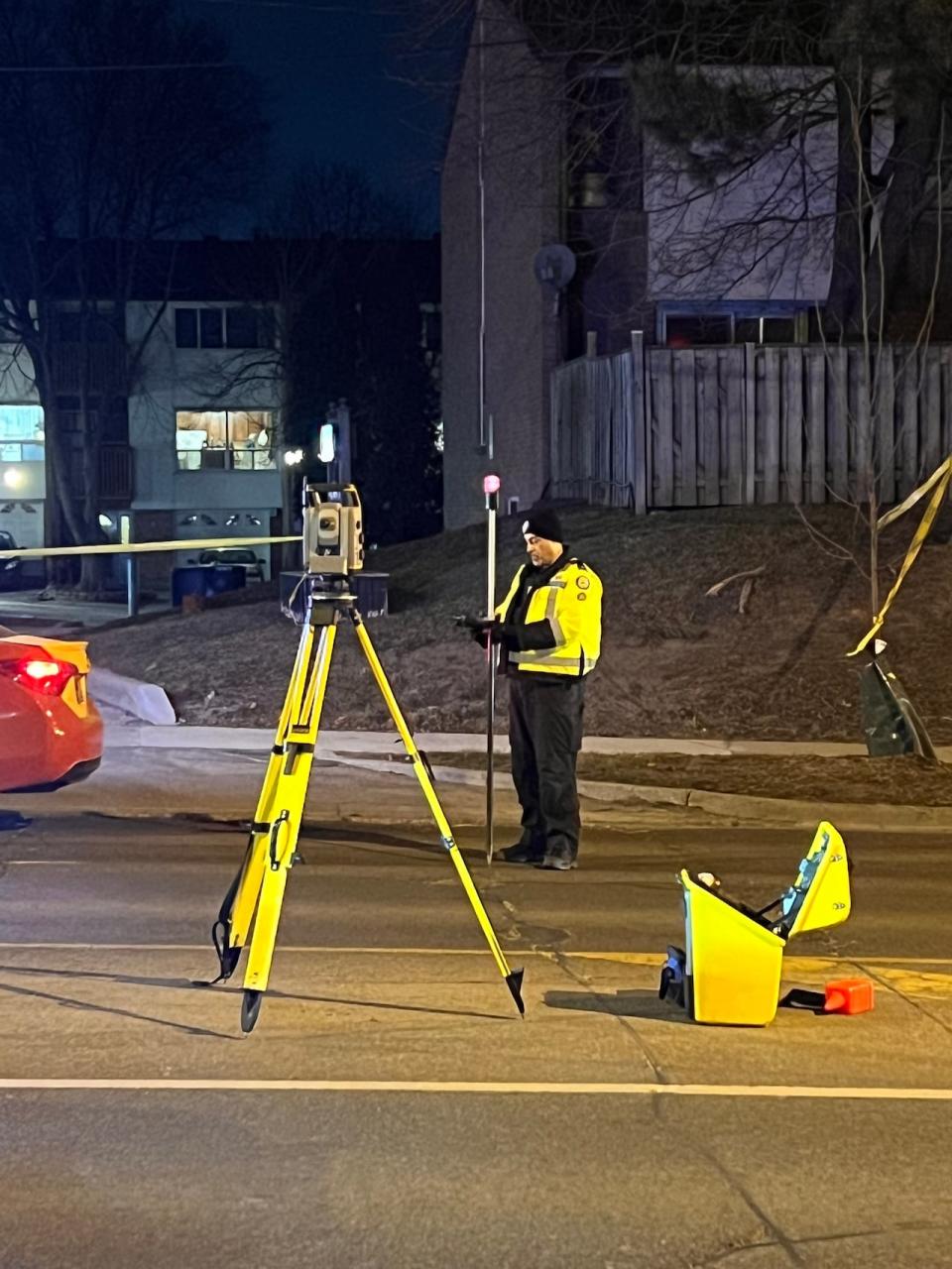 A Toronto police officer investigates after a cyclist was fatally struck in Scarborough on Monday. (Darek Zdzienicki/CBC - image credit)