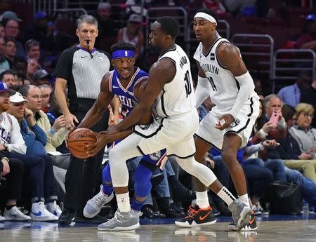 Mar 28, 2019; Philadelphia, PA, USA; Philadelphia 76ers guard Jimmy Butler (23) is pressured by Brooklyn Nets guard Theo Pinson (10) and forward Rondae Hollis-Jefferson (24) during the fourth quarter at Wells Fargo Center. Mandatory Credit: Eric Hartline-USA TODAY Sports