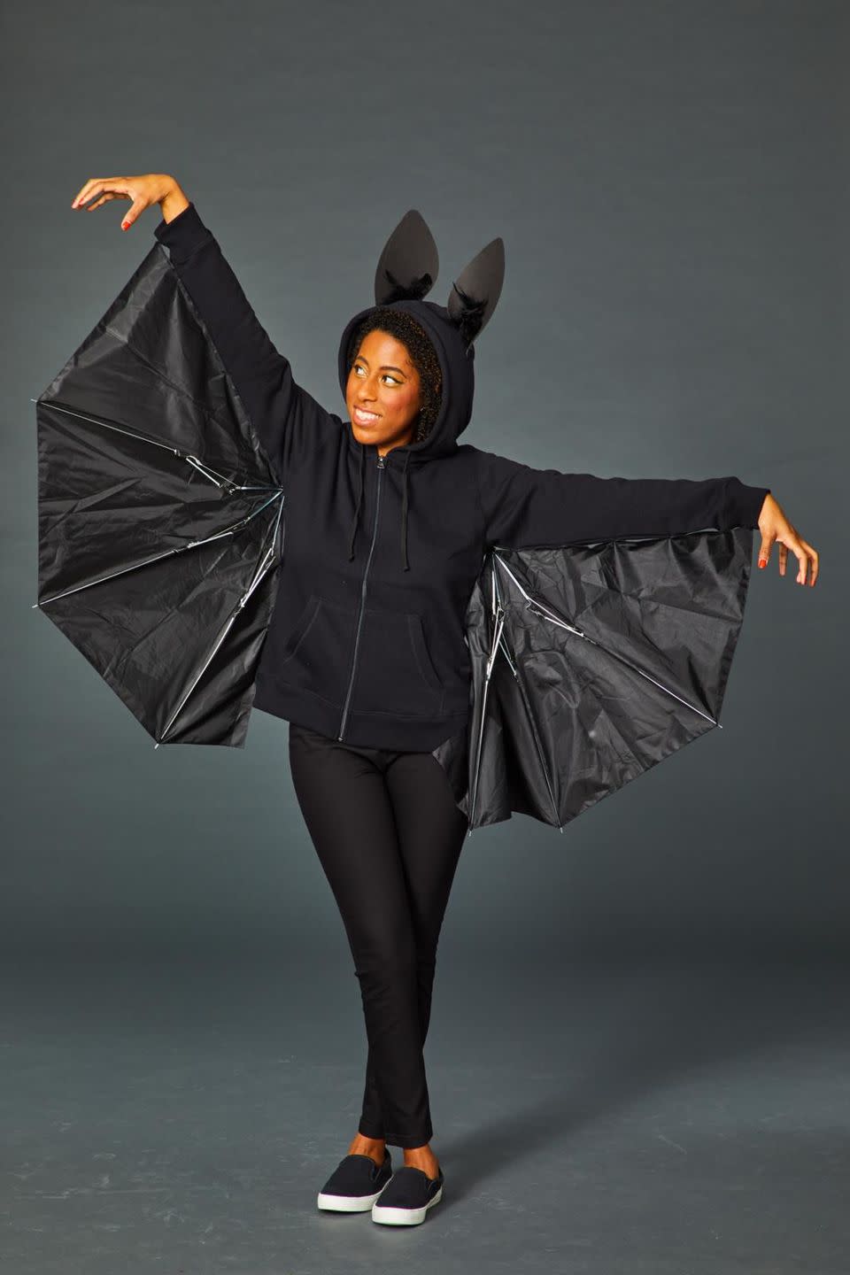 <p>Don't throw out your broken umbrella just yet! Cut it in half and use use black safety pins or hot glue to attach it to the arms of a black hoodie. Fasten the hinges of the umbrella pieces with black electrical tape, so you can open your wings to get the full bat effect. Finish it off with black foam ears, dotted with black feathers. </p>