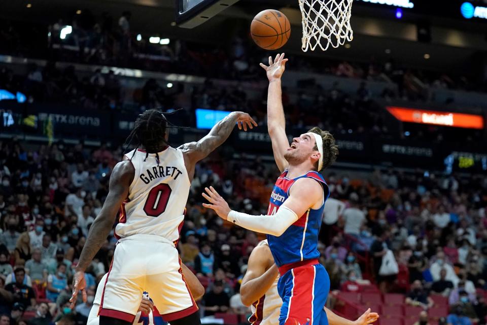 Washington Wizards forward Corey Kispert, right, goes to the basket as Miami Heat guard Marcus Garrett (0) defends during the first half of an NBA game on Dec. 28, 2021, in Miami. Garrett, who played in college at Kansas, spent this year's summer league games in Las Vegas with the Heat.