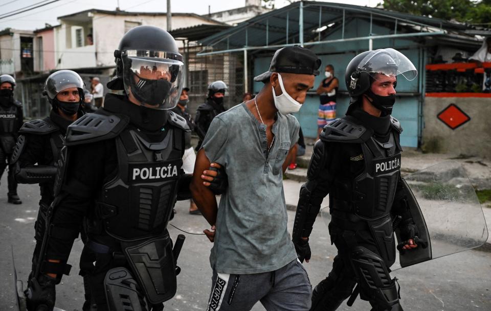 TOPSHOT - A man is arrested during a demonstration against the government of President Miguel Diaz-Canel in Arroyo Naranjo Municipality, Havana on July 12, 2021. - Cuba on Monday blamed a 