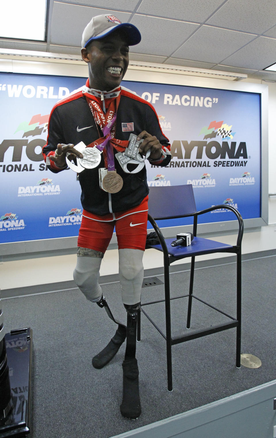 Paralympian Blake Leeper poses for photos during a news conference before the NASCAR Daytona 500 Sprint Cup series auto race at Daytona International Speedway in Daytona Beach, Fla., Sunday, Feb. 23, 2014. Leeper will deliver the green flag to start the race. (AP Photo/Terry Renna)