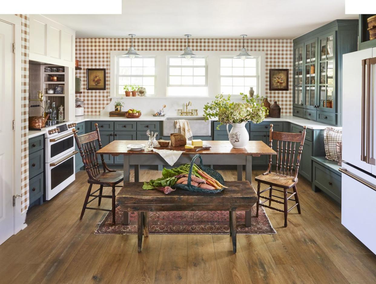 farmhouse kitchen of north carolina homeowner ronnie thompson with green cabinets and gingham wallpaper