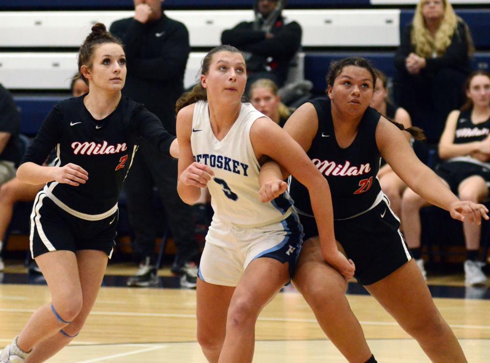 Petoskey sophomore Caitlyn Matelski fights through a pair of Milan players for a rebound during the second half Friday.