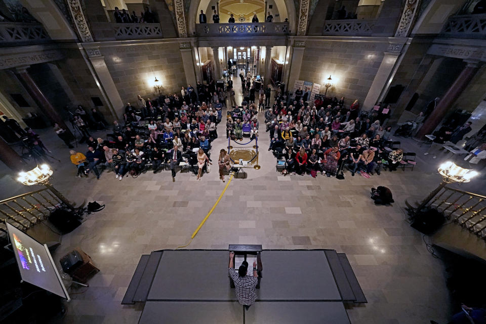 People listen to a speaker during a rally in favor of a ban on gender-affirming health care legislation, Monday, March 20, 2023, at the Missouri Statehouse in Jefferson City, Mo. (AP Photo/Charlie Riedel)