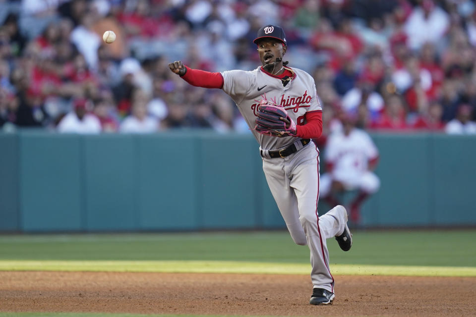 Washington Nationals shortstop Dee Strange-Gordon (9) throws to first to out Los Angeles Angels' David Fletcher during the third inning of a baseball game in Anaheim, Calif., Saturday, May 7, 2022. (AP Photo/Ashley Landis)