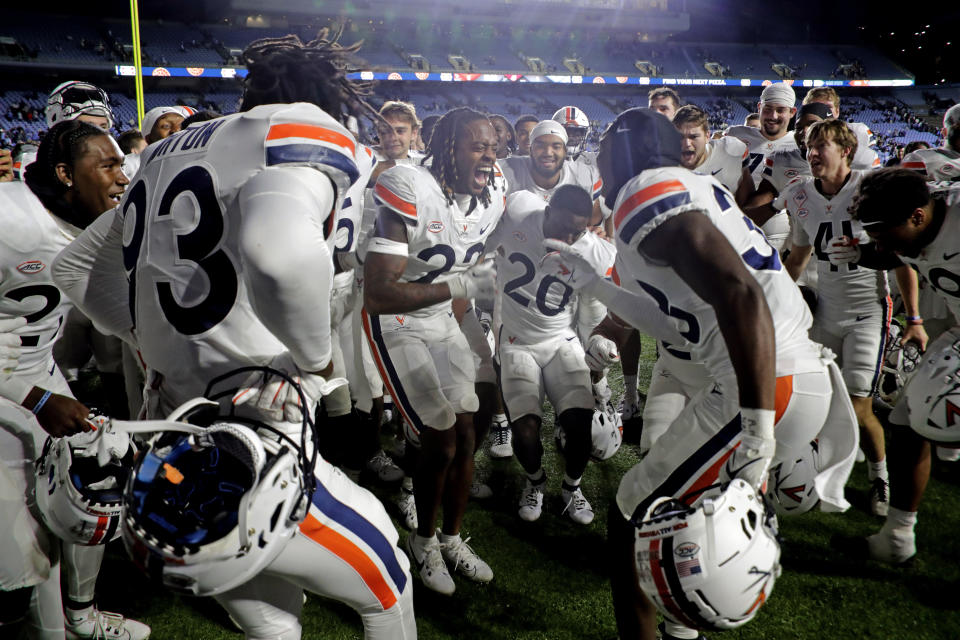 Virginia players celebrate after their upset win over North Carolina on Saturday, Oct. 21, 2023, in Chapel Hill, N.C. (AP Photo/Chris Seward)