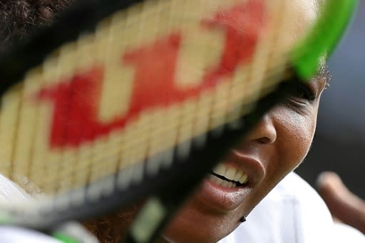 Serena Williams returns against Camila Giorgi during their quarter-final at the All England Club