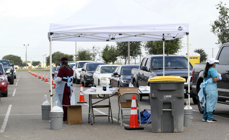 Health officials and members of the military assist during COVID-19 testing, Wednesday, July 8, 2020, at HEB Park in Edinburg, Texas. (Delcia Lopez/The Monitor via AP)