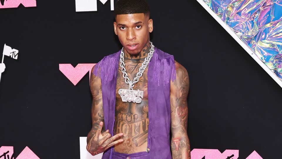 NLE Choppa went for cowboy chic with a purple fringed suede two-piece and a heavy bejeweled "Cotton Wood" chain necklace.  - Jamie McCarthy/WireImage/Getty Images