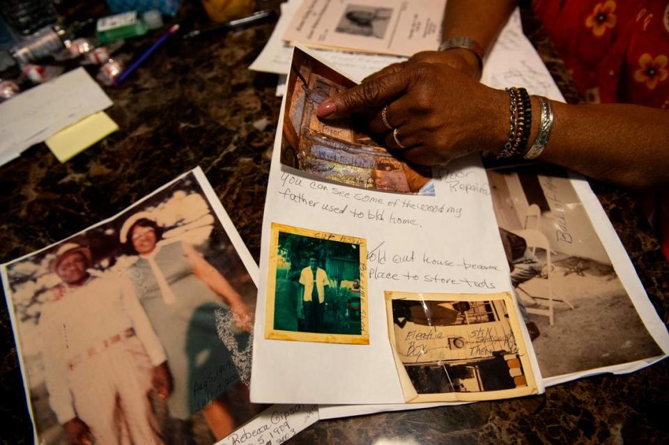 Mary Gipson shows photos of her family and their home on School Street in Ocean Springs on Tuesday, Sept. 26, 2023. She is the youngest of 14 children born to Rebecca McDaniel Gipson and Wilbert Gipson Sr.