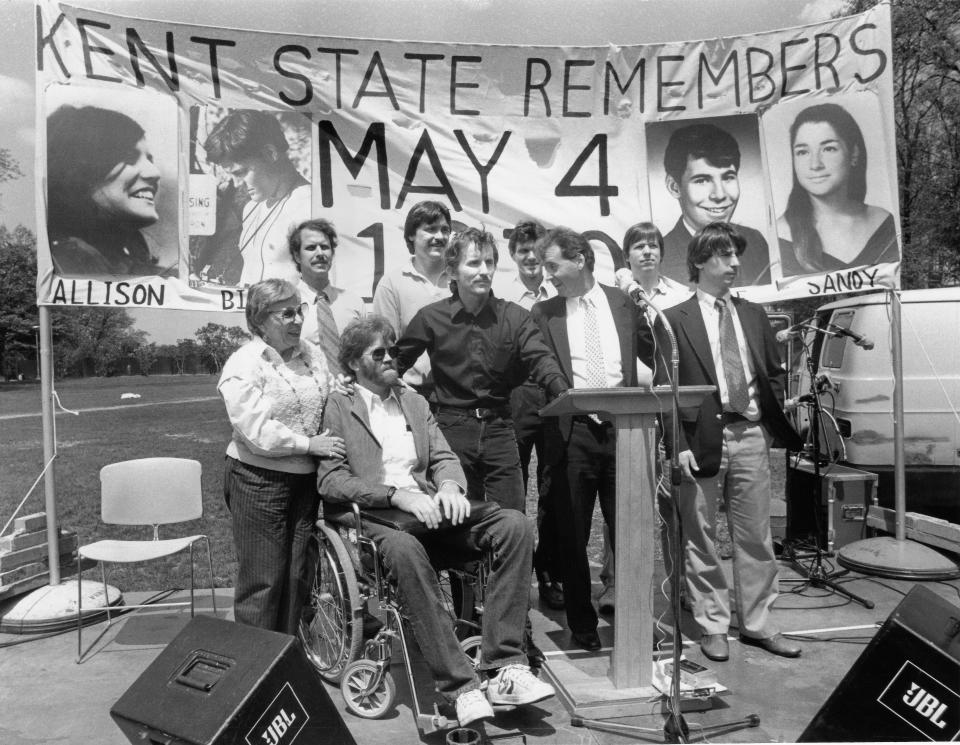 Eight of the nine students who were wounded on May 4, 1970, attend the annual commemoration ceremony on May 4, 1985. They were joined by Elaine Holstein, the mother of Jeffrey Miller, one of the four slain students. They include Dean Kahler, Alan Canfora (in black shirt), Robert Stamps, James Russell, Tom Grace, Joseph Lewis Jr., Donald Scott MacKenzie, and Douglas Wrentmore.