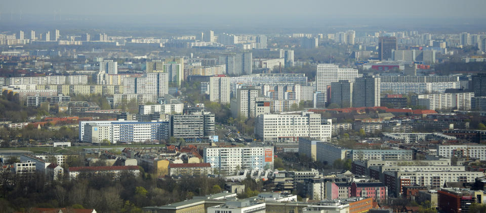 FILE - In this Thursday, April 4, 2019, file photo, Apartment buildings in the former east part of the German capital photographed from the television tower in Berlin, Germany. The city of Berlin is freezing the rent of 1.5 million apartments for the next five years starting this Sunday in a controversial move to control the exploding costs that have forced many to move outside the city. Berlin is the first city in Germany to influence the rental prices so directly and the law has been both celebrated as a step toward more fairness by its supporters and ripped apart as a socialist method by critics. (AP Photo/Markus Schreiber, file)